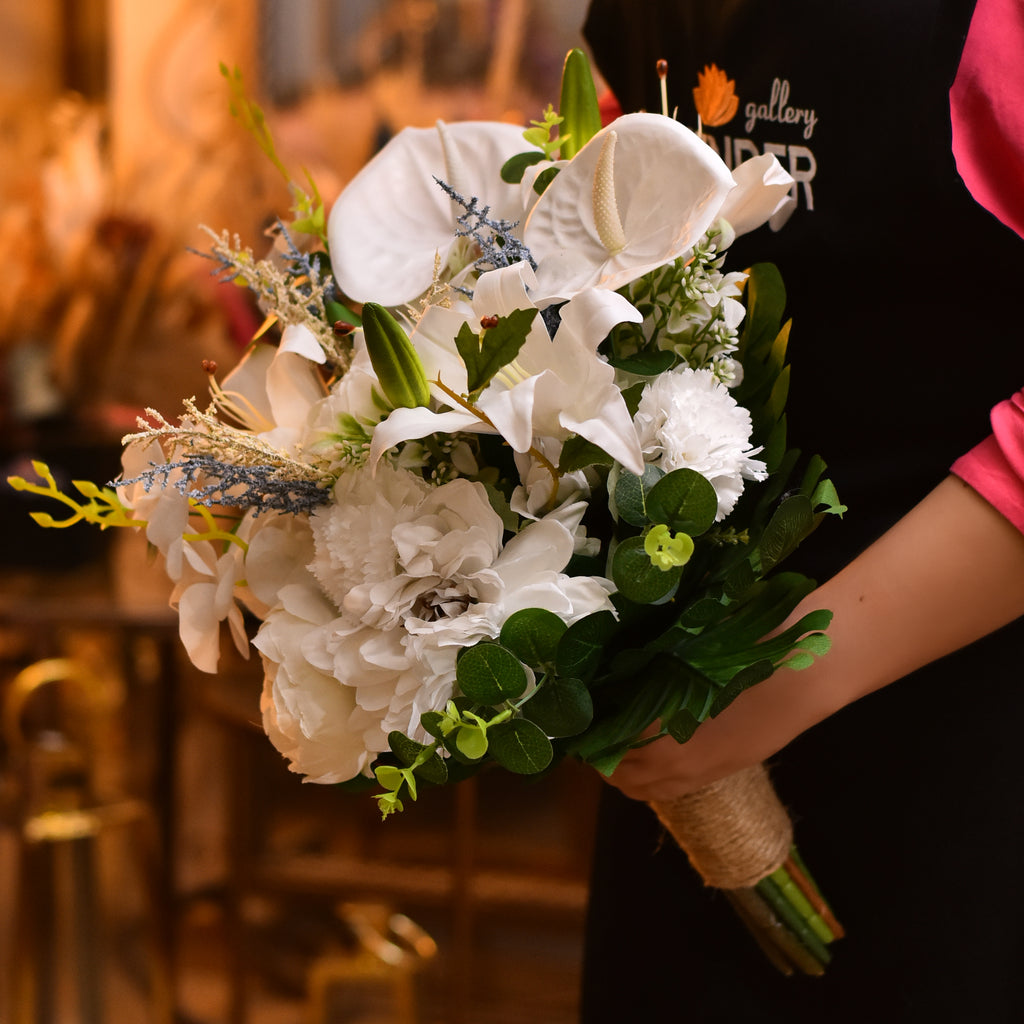 Artificial white anthurium .Artificial white lilies.Artificial white carnation.Artificial white large gerbera .Artificial white and blue lavender and Artificial green leaves