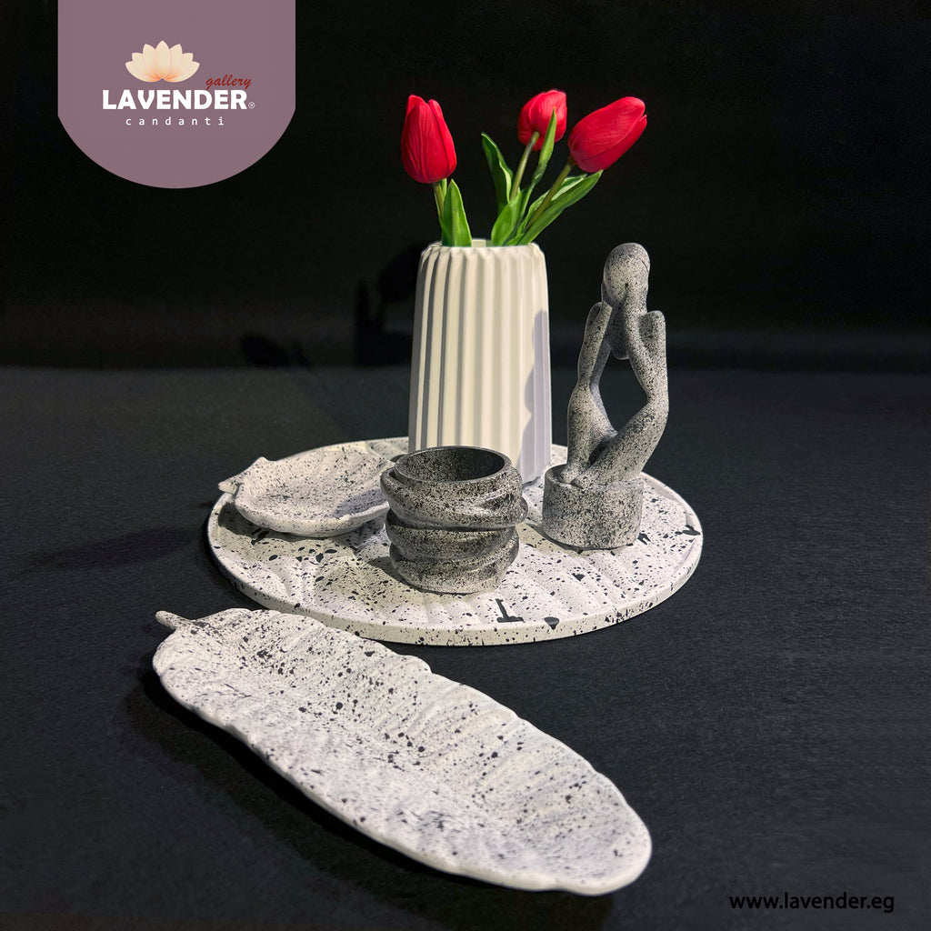 Decorative stone items including a vase with red tulips 