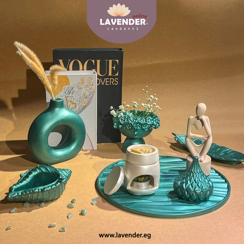 Decorative items including a teal vase, candle holder, and figurine 