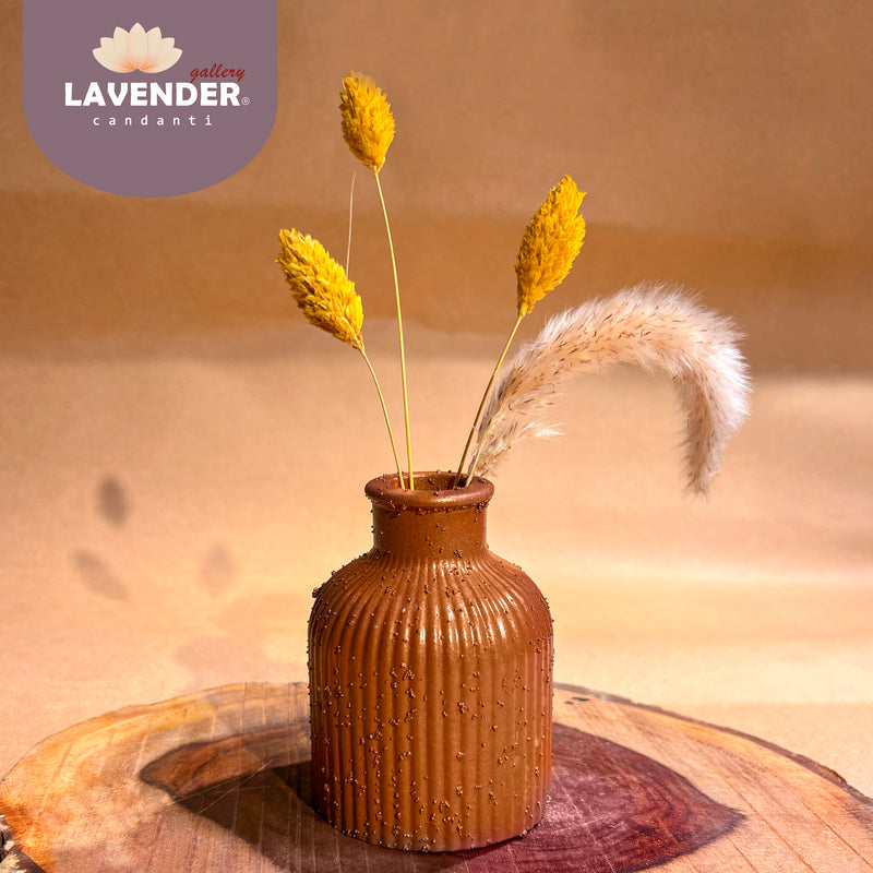 Brown textured vase with dried plants 