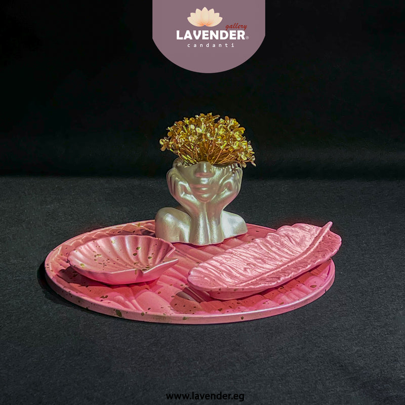 Decorative piece with a silver bust and gold flowers on a pink base