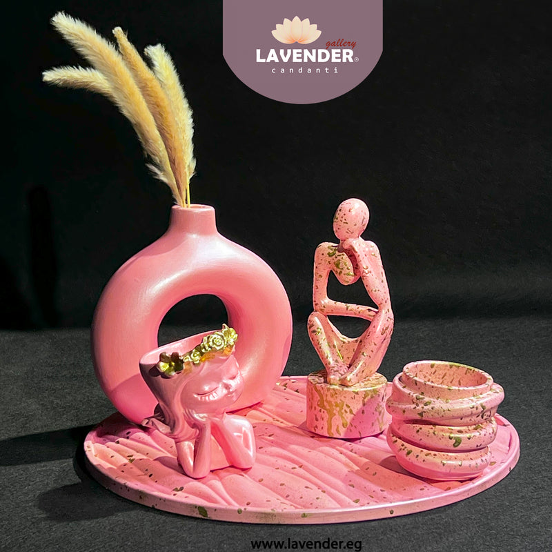 Pink decorative set with a vase, figurines, and bowls 