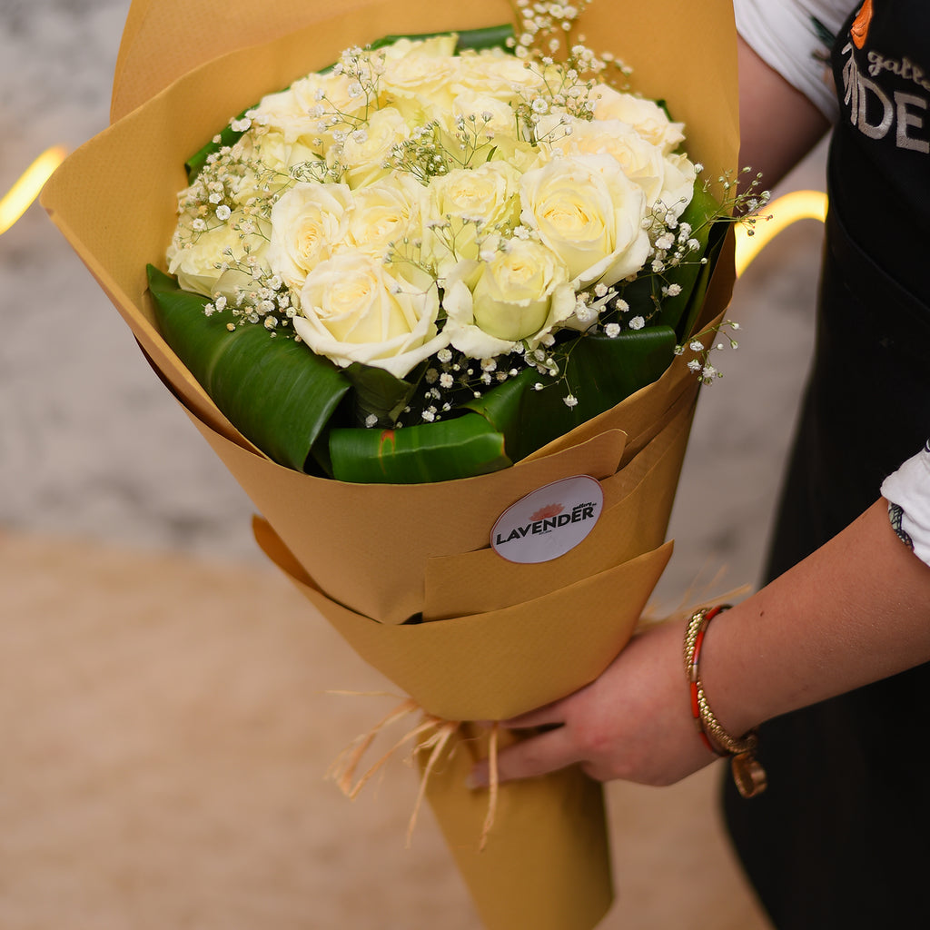 white roses .white gypsophila and green leaves