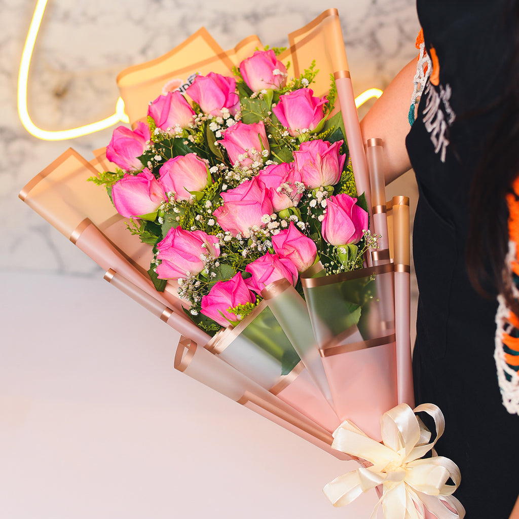 Pink roses .white gypsophila and green leaves