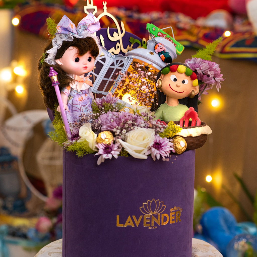 Decorative purple box with dolls and flowers, featuring the Lavender brand logo.